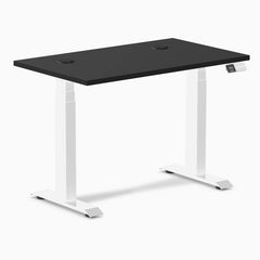Desky Dual Mini sit-stand desk with a black 40x24 inch top, white frame, and grommets.