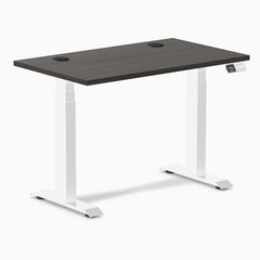 Desky Dual Mini sit-stand desk with burnished wood 40x24 inch top, white frame, and grommets.