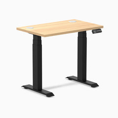 Desky Dual Mini sit stand desk with Sublime Teak 32x20" top, matte black frame, and grommets.