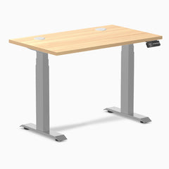 Desky Dual Mini sit-stand desk with a Sublime Teak 40x24 inch top, gray frame, and grommets.