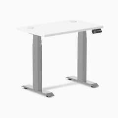 White Desky Dual Mini sit-stand desk, 32x20 inches, with grommets and gray frame.