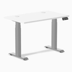 White Desky Dual Mini sit-stand desk, 40x24 inches, with gray legs and two grommets.