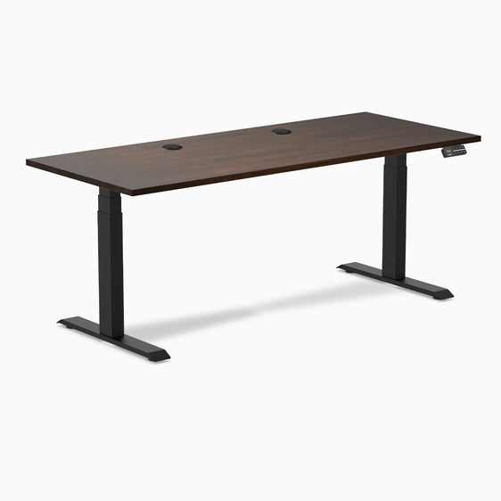 Dual rubberwood standing desk in dark walnut top with grommets