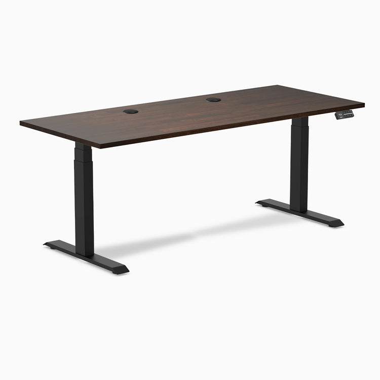 Dual rubberwood standing desk in dark walnut top with grommets
