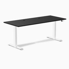 Desky Dual laminate sit-stand desk with black top, white frame, and two grommets.