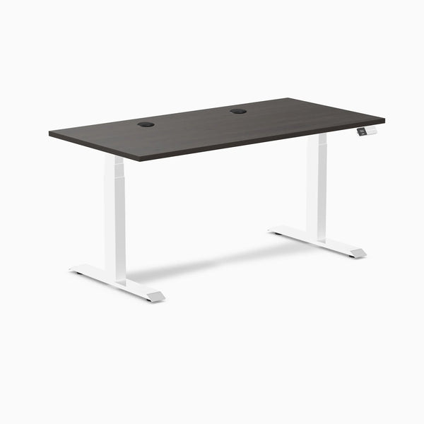 Burnished wood laminate sit-stand desk, 59.1x29.5 inches, with grommets and white frame.