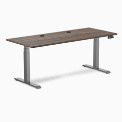 Desky Dual sit-stand desk with Jarrah Legno laminate top, Space Gray legs, and two grommets.