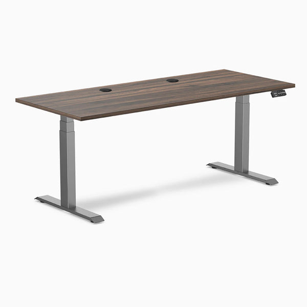 Desky Dual sit-stand desk with Jarrah Legno laminate top, Space Gray legs, and two grommets.