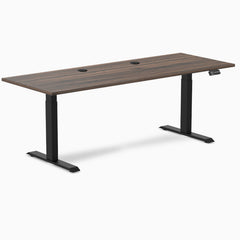 Desky Dual sit stand desk with Jarrah Legno laminate top, two grommets, and matte black legs.