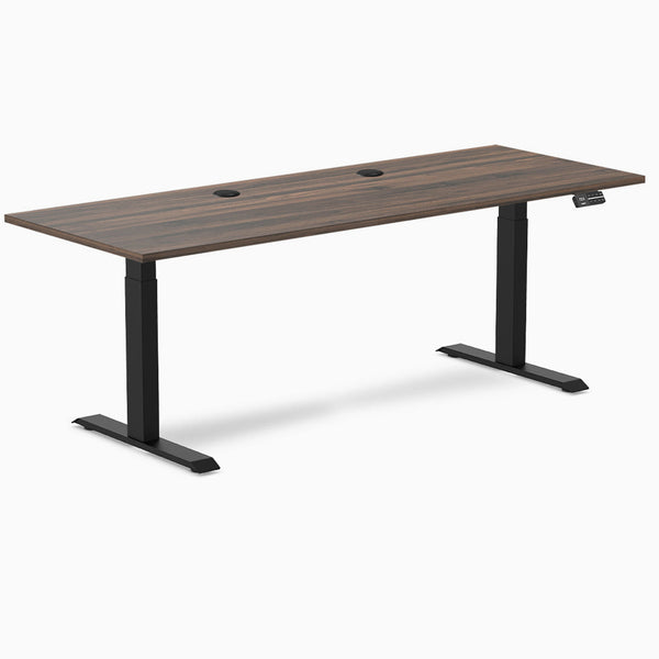Desky Dual sit stand desk with Jarrah Legno laminate top, two grommets, and matte black legs.