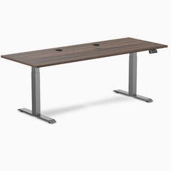 Desky Dual Laminate Sit Stand Desk with Jarrah Legno top, Space Gray legs, 78.7x29.5 inches, and grommets.
