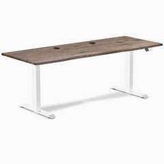 Desky Dual sit-stand desk with natural walnut laminate top, two grommets, and white frame.
