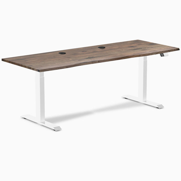 Desky Dual sit-stand desk with natural walnut laminate top, two grommets, and white frame.