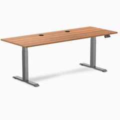 Desky Dual Prime Oak laminate sit-stand desk, 78.7x29.5 inches, with two grommets and Space Gray frame.