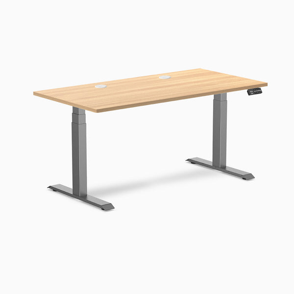 Desky Dual sit-stand desk with Sublime Teak laminate top, two grommets, and Space Gray frame.