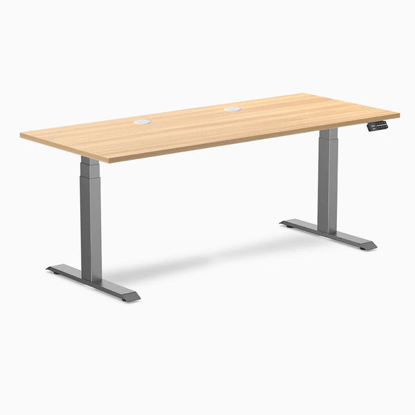 Desky Dual Laminate Sit Stand Desk with Sublime Teak top, Space Gray frame, and two grommets.
