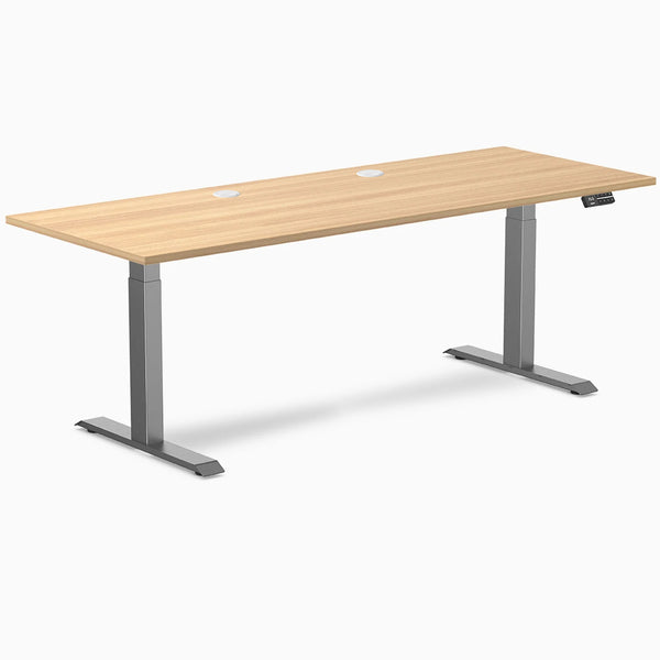 Desky Dual sit-stand desk with Sublime Teak laminate top, Space Gray frame, and grommets.