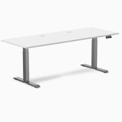 White Desky Dual Laminate Sit Stand Desk with Space Gray frame, 78.7 x 29.5 inches, and two grommets.