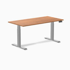 Desky Dual Custom Laminate Sit Stand Desk with a warm woodgrain top and silver adjustable legs.
