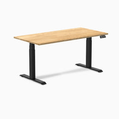 Desky Dual 60x30 inch White Oak hardwood sit-stand desk with matte black legs and control panel.