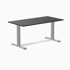 Desky Zero laminate office desk with a dark wood-grain top and silver steel I-frame legs.